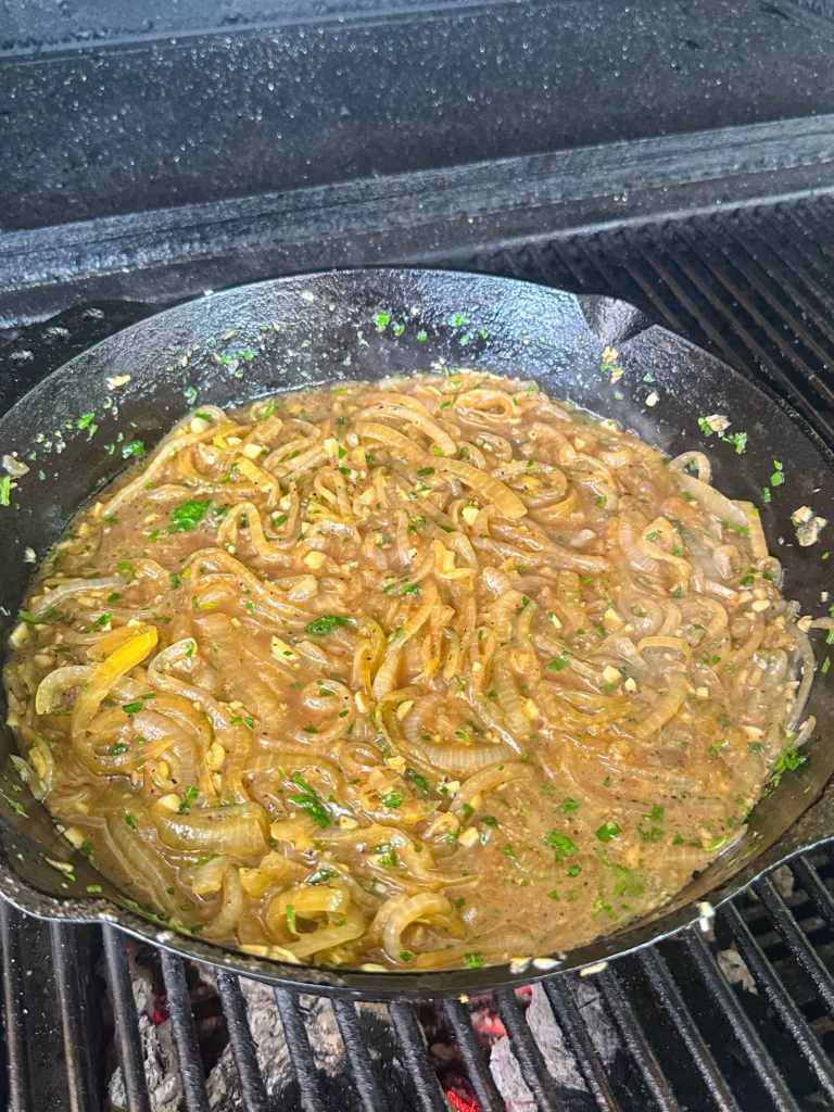 cooking the onions on a cast iron