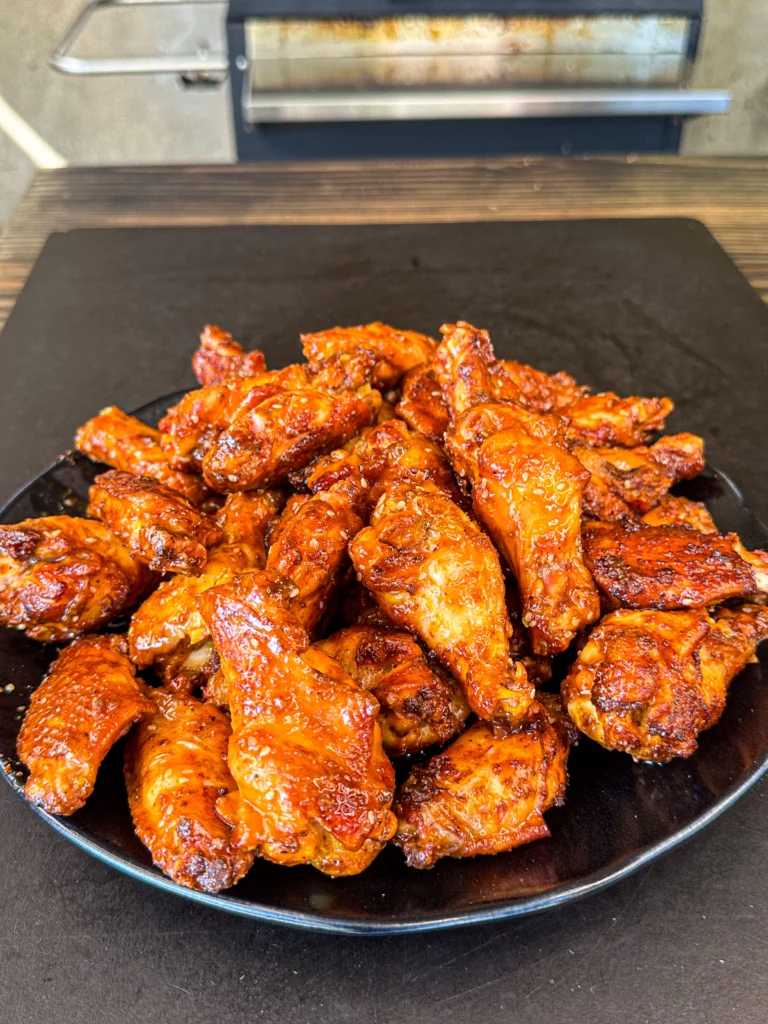 smoked and fried chicken wings with a hot honey garlic sauce