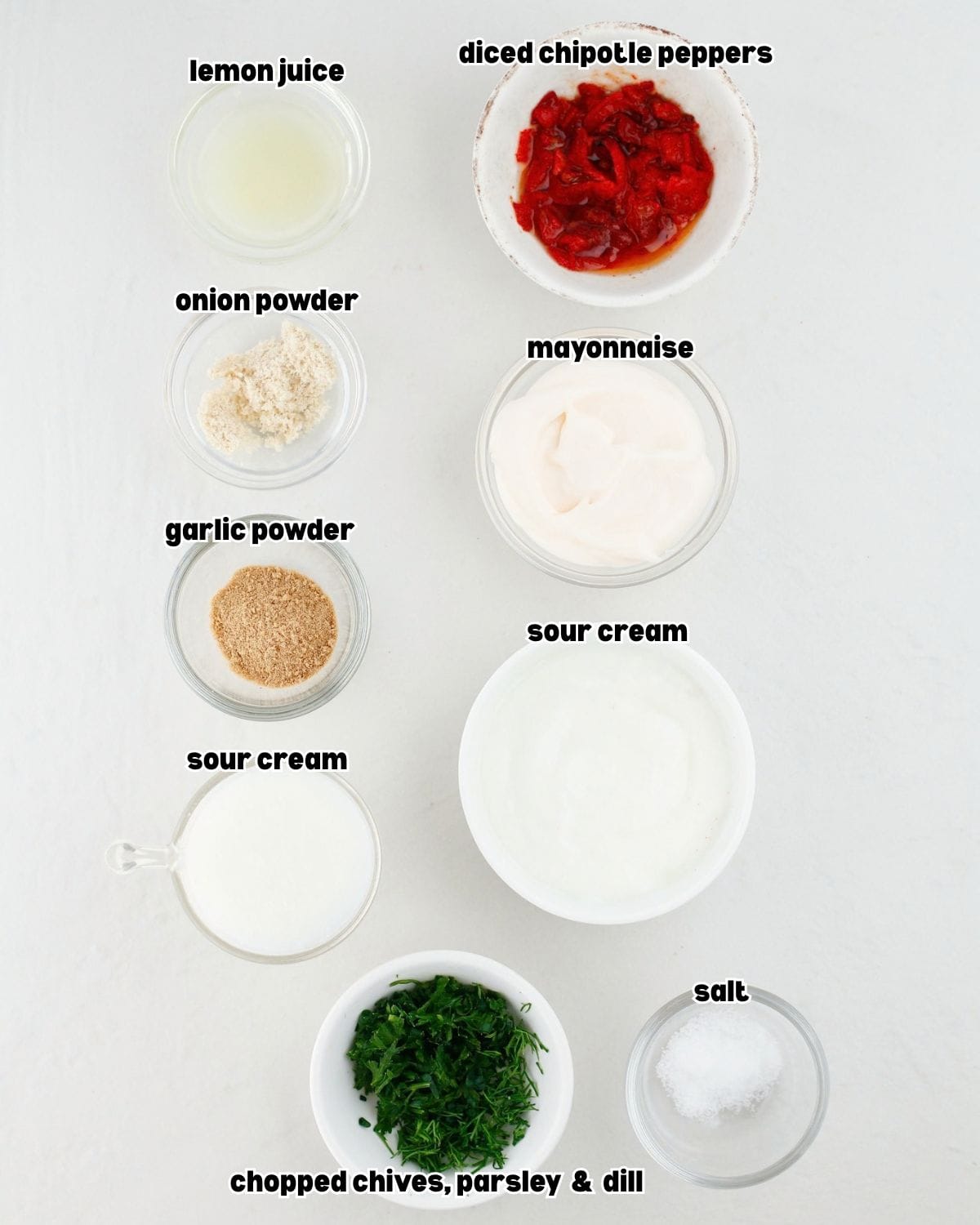 individual bowls of ingredients for Chipotle ranch sauce placed on a clean kitchen countertop.