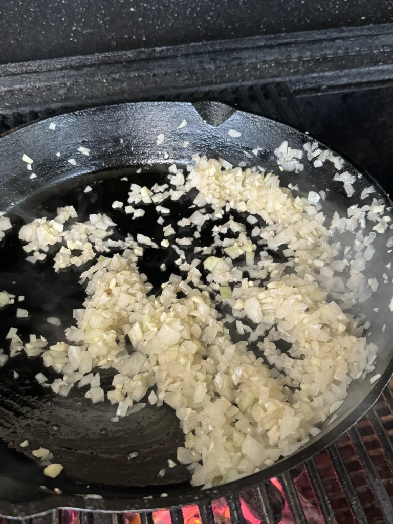 cooking the onions and garlic in a cast iron