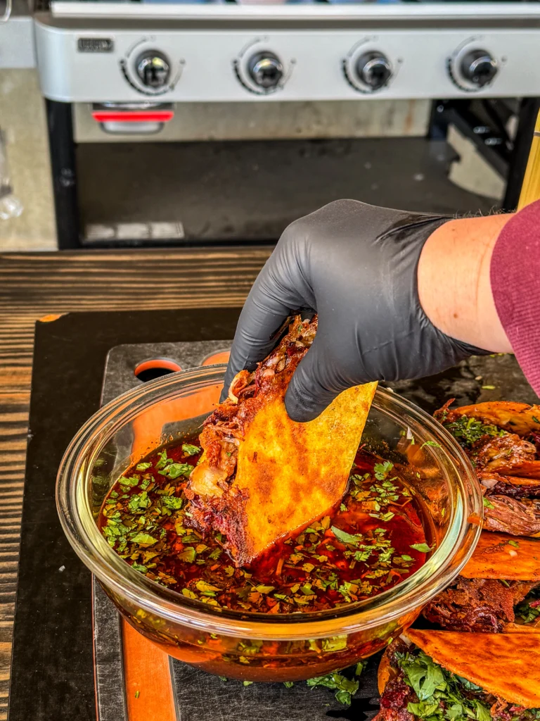 dipping tacos in the sauce