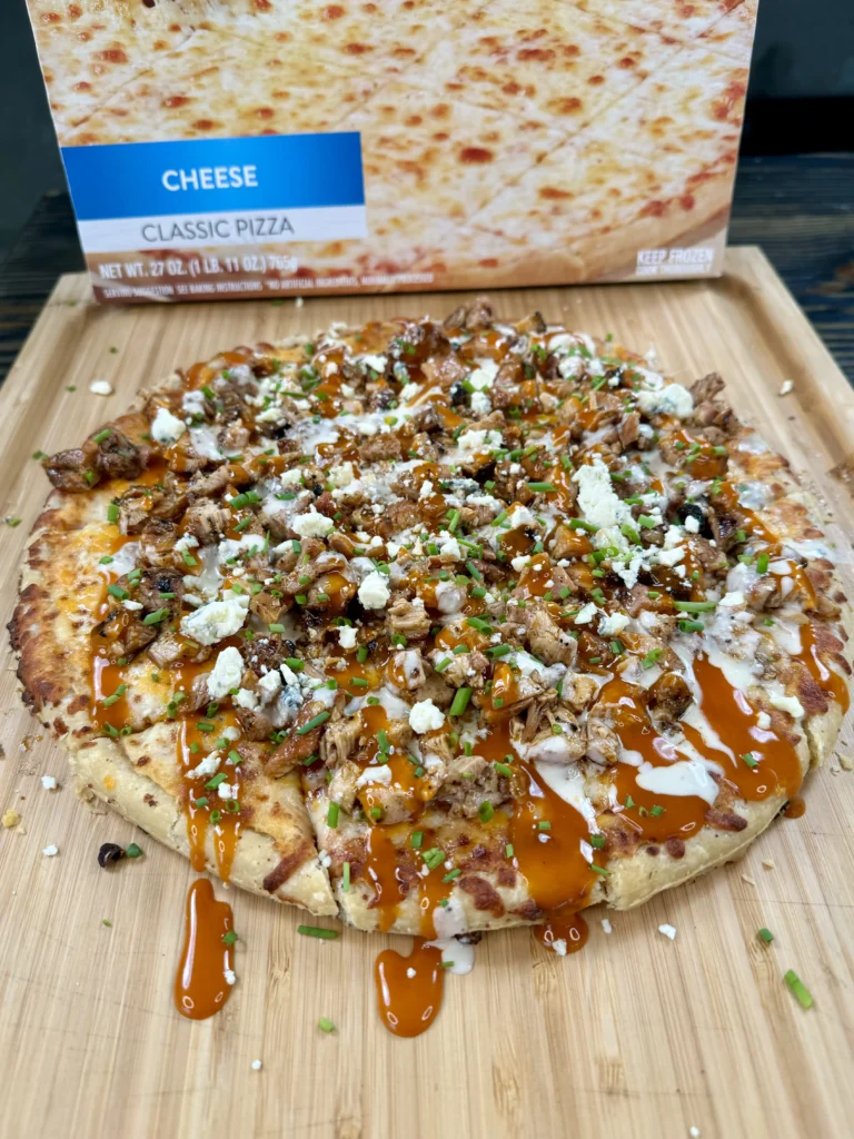 smoked buffalo chicken pizza on a cutting board