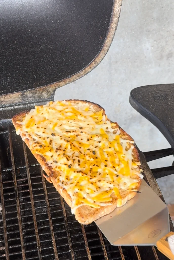 prepping the bread for a steak sandwich