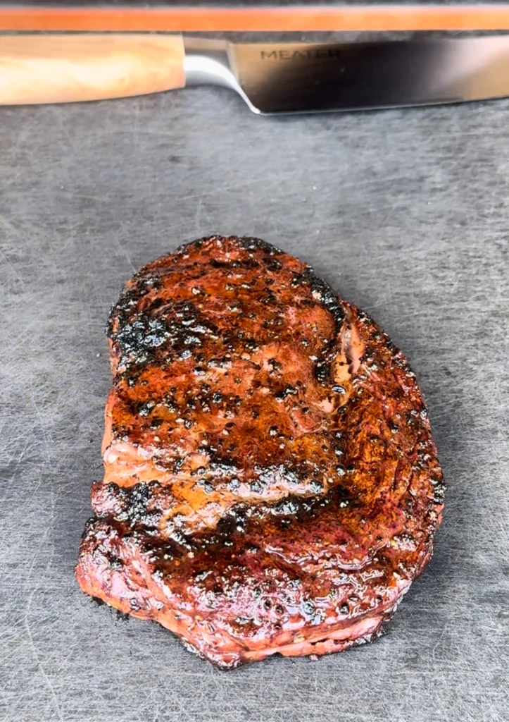 resting steak on a cutting board