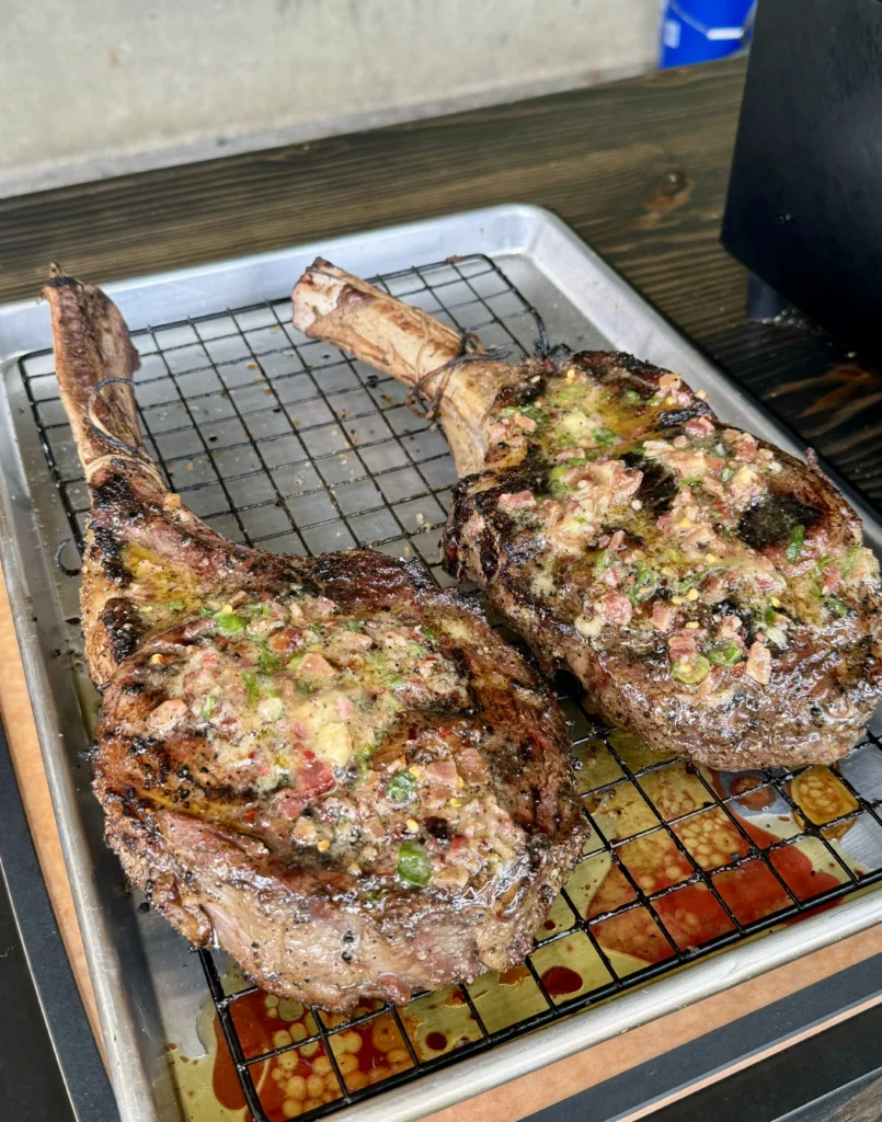 steaks resting with a compound butter on top of them