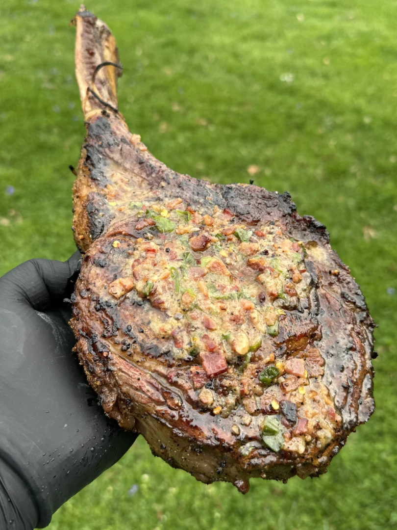 steak with candied bacon on it