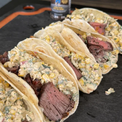 elote steak tacos on a cutting board