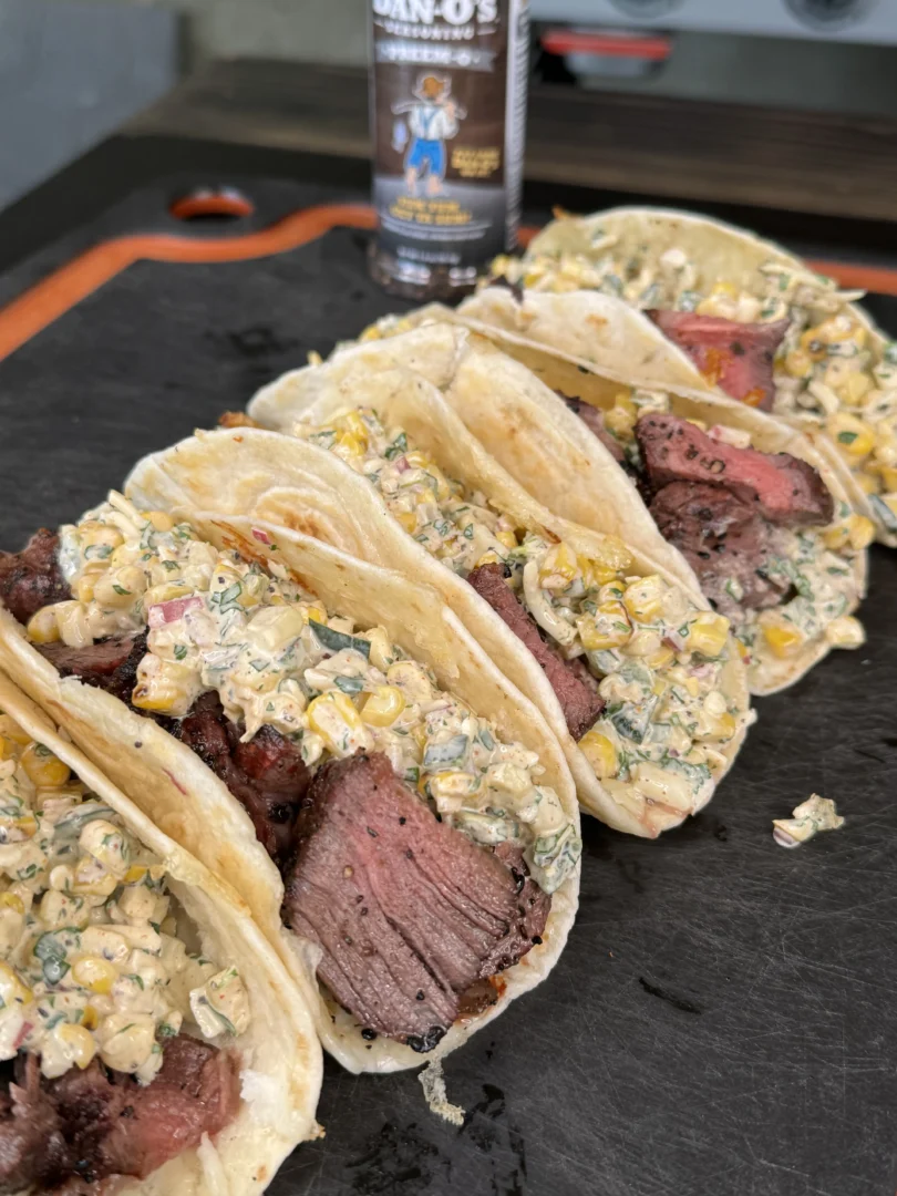 elote steak tacos on a cutting board