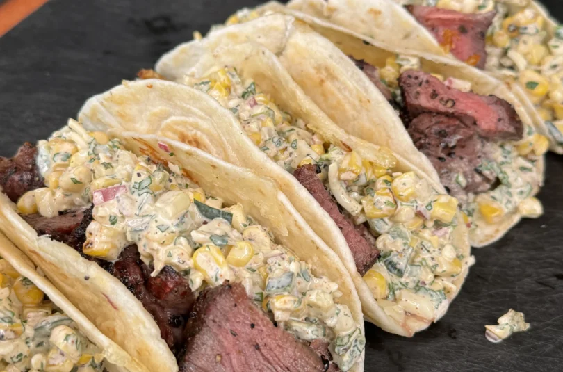 elote steak tacos on a cutting board
