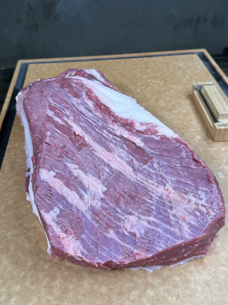 whole packer brisket on a cutting board