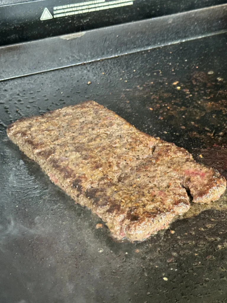 cooking the patty on the griddle