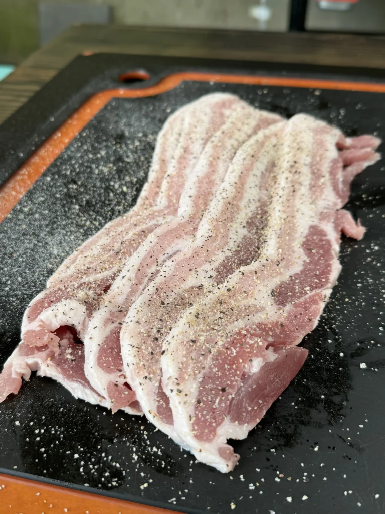 seasoned pork belly on the cutting board