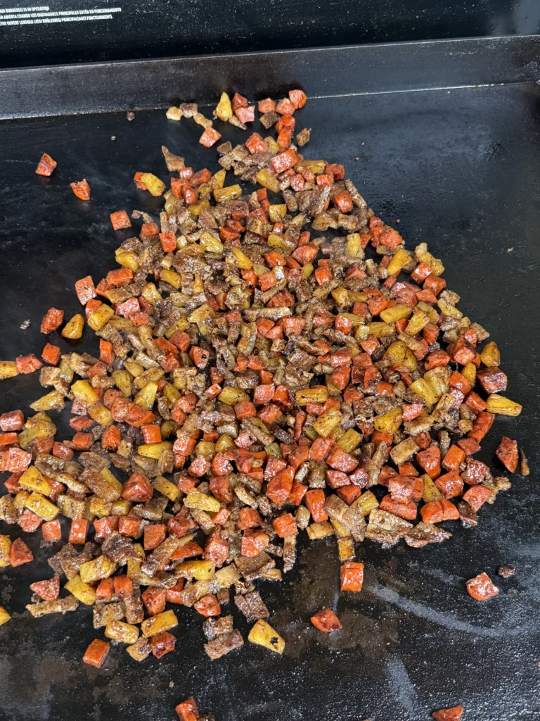 cooking the contents of the tacos on the grill