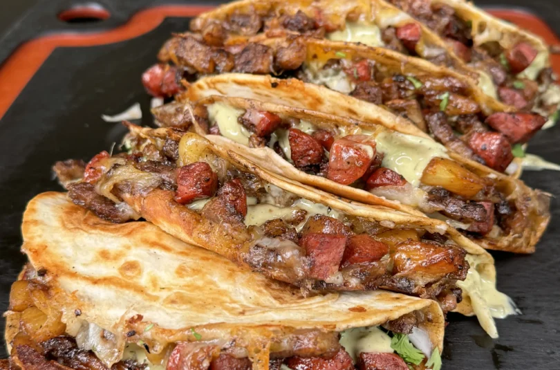 crispy pork belly tacos on the cutting board