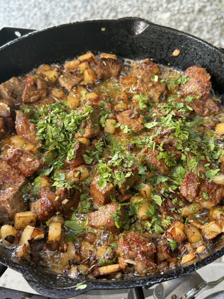 steak and potatoes in the cast iron