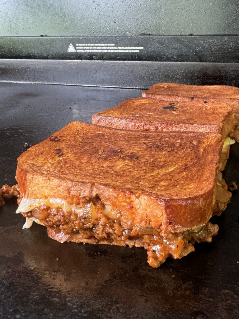 stacked grilled cheese on the grill
