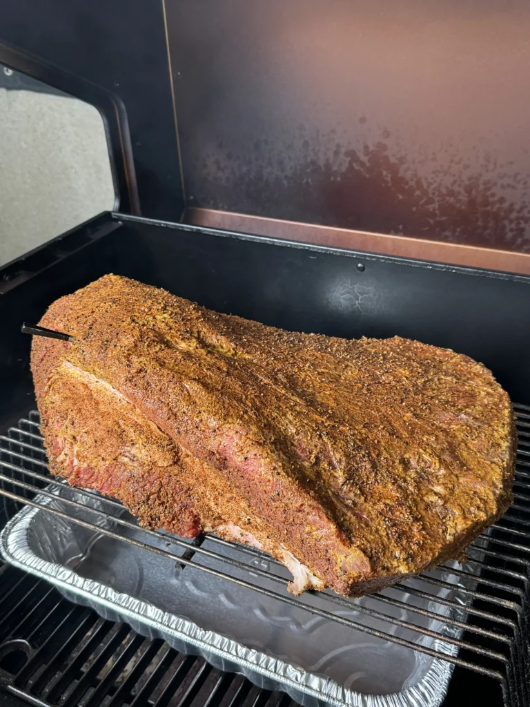 seasoned brisket on the smoker