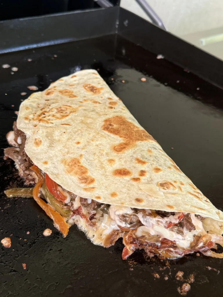 tortilla on the griddle with fillings