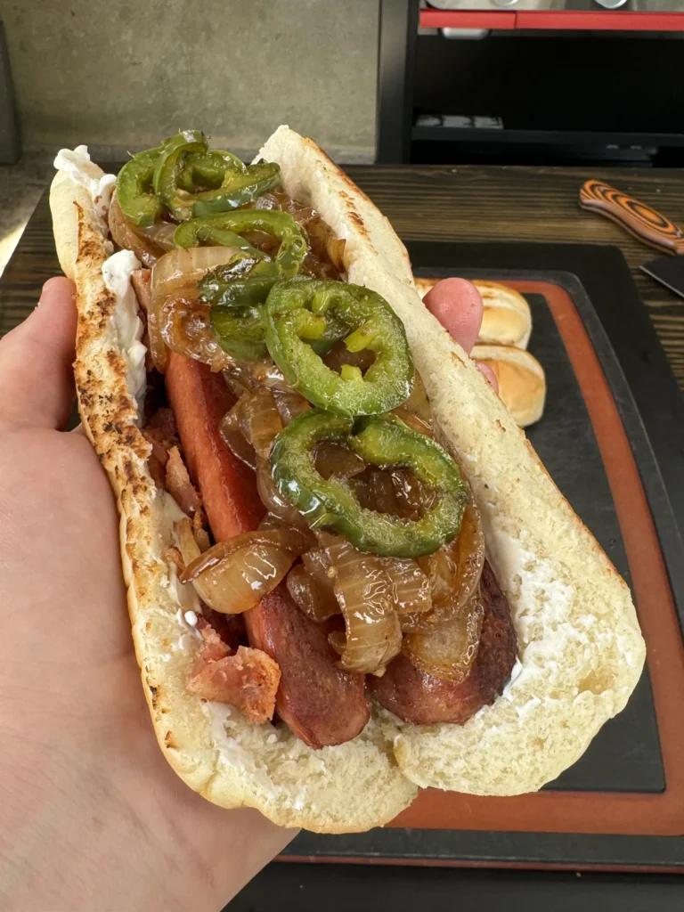holding a finished hot dog