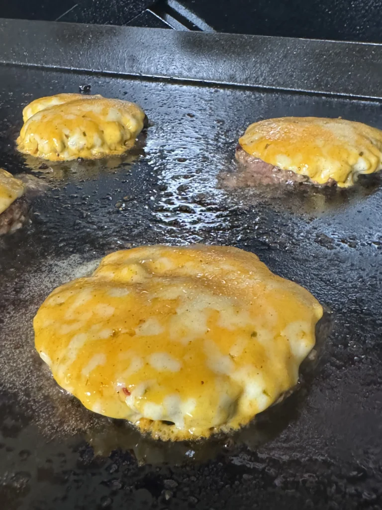 patties on the grill with cheese