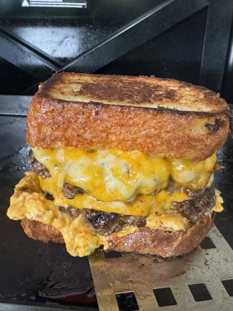 up close on the smash burgers with a spatula