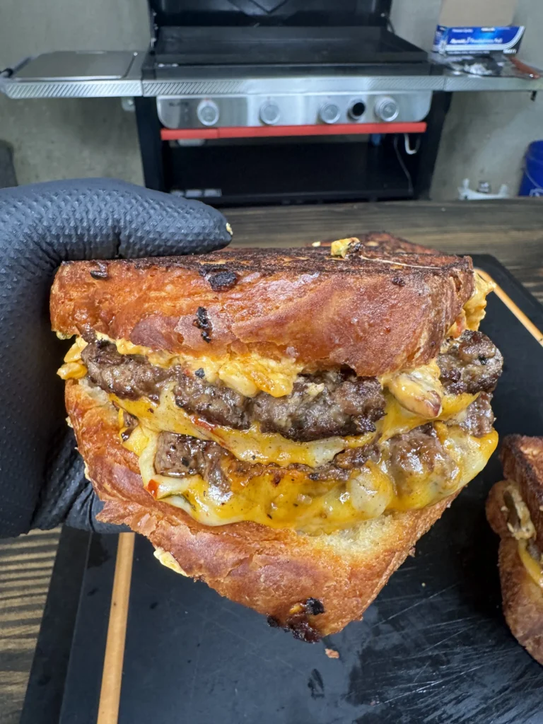 holding the patty melt over a cutting board