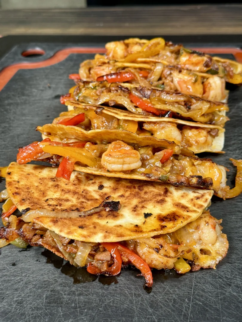 row of Andouille sausage and shrimp tacos