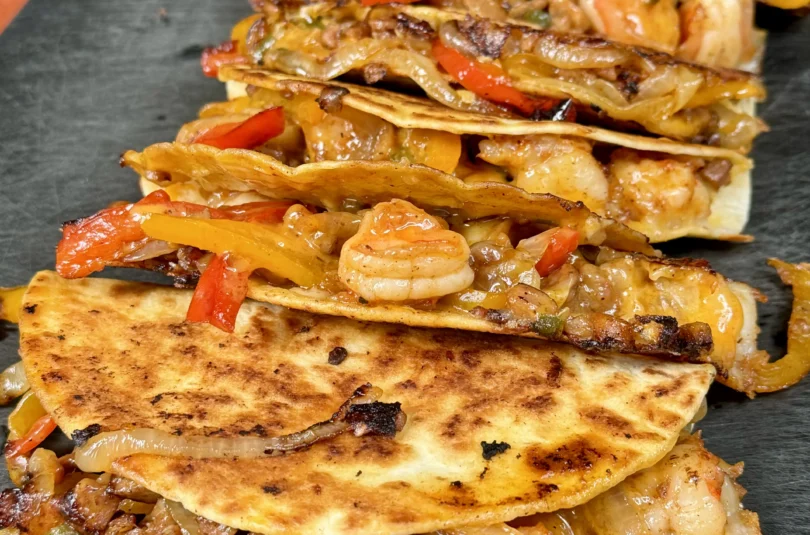 row of Andouille sausage and shrimp tacos