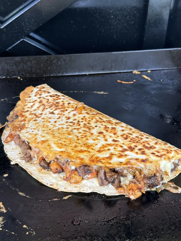 cooking quesadilla on the flat top
