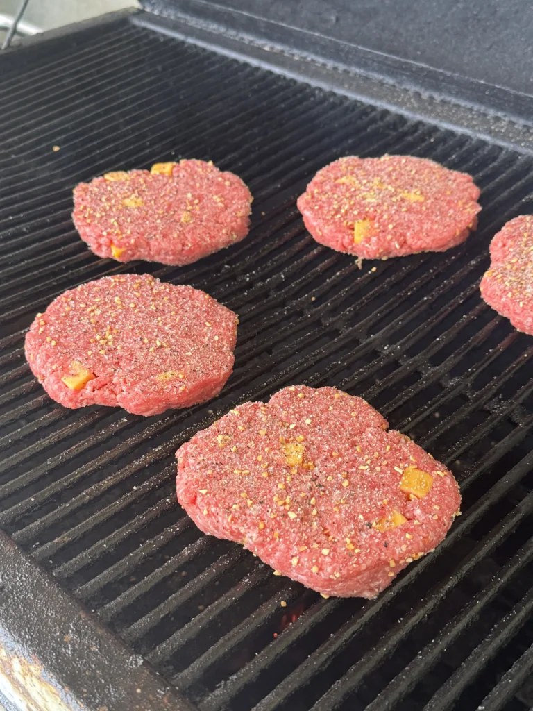 smoking the cheese burgers on the hasty bake