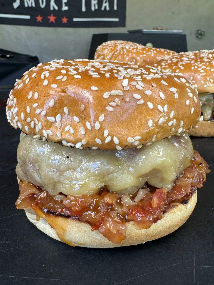smoked bacon jam burgers on a cutting board