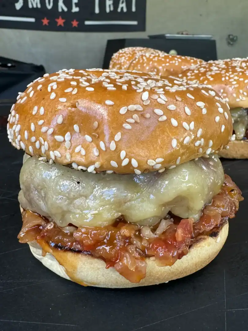 smoked bacon jam burgers on a cutting board