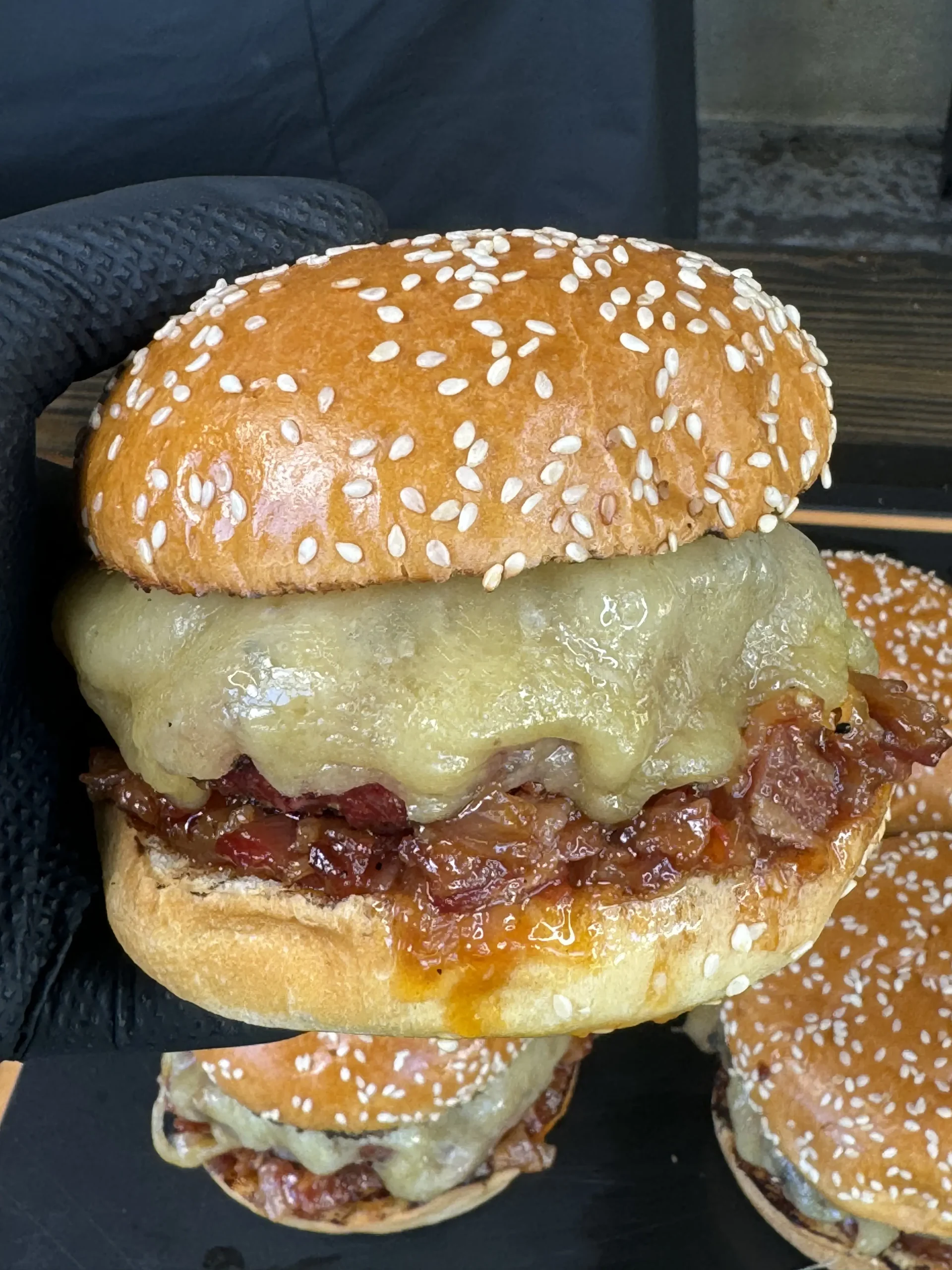 holding a bacon jam burger