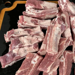 cut up party ribs on a cutting board