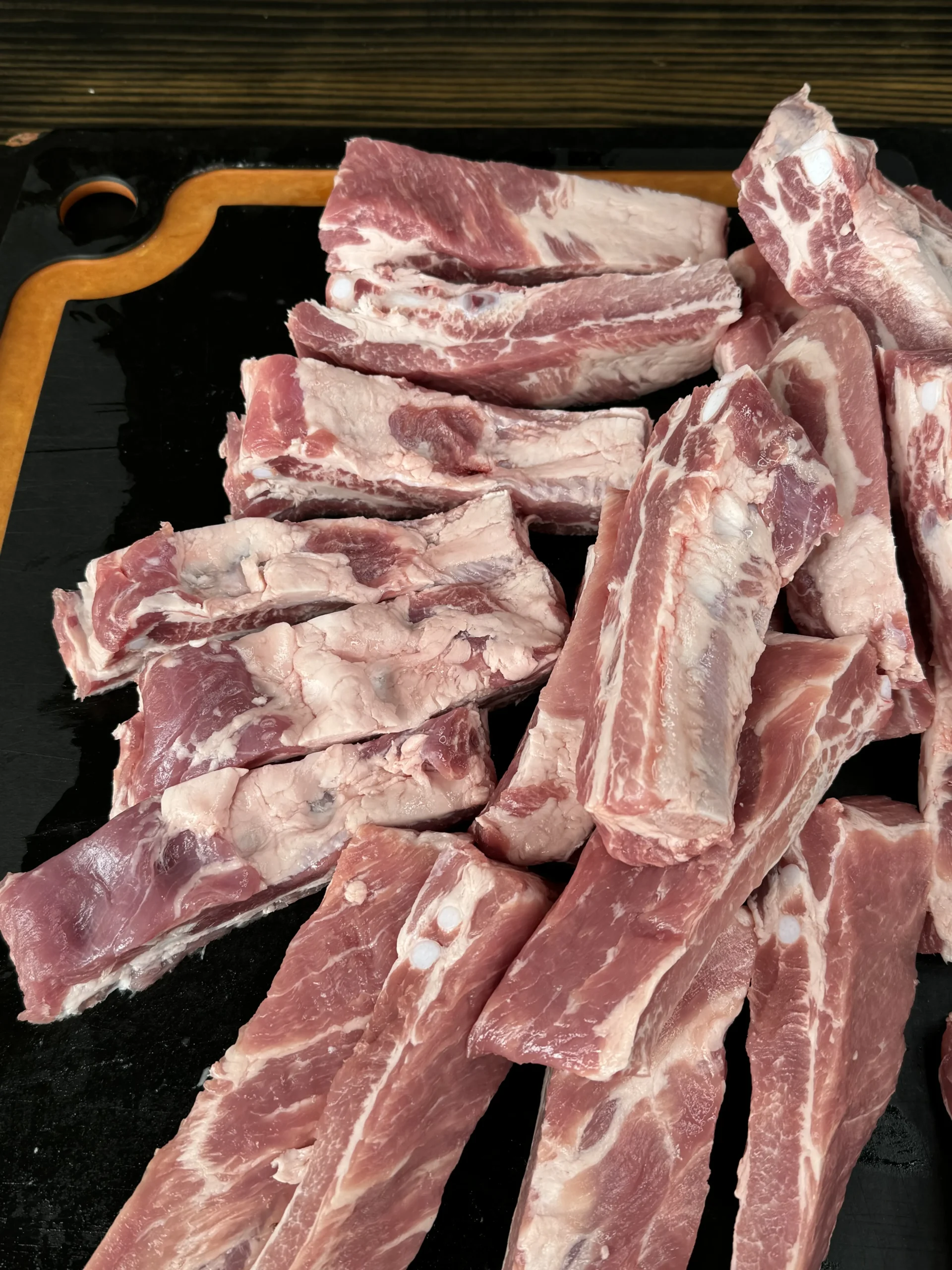 cut up party ribs on a cutting board