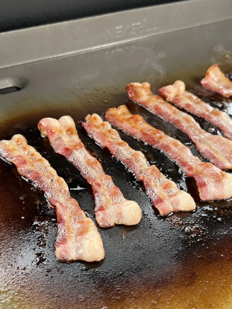 bacon cooking on the griddle
