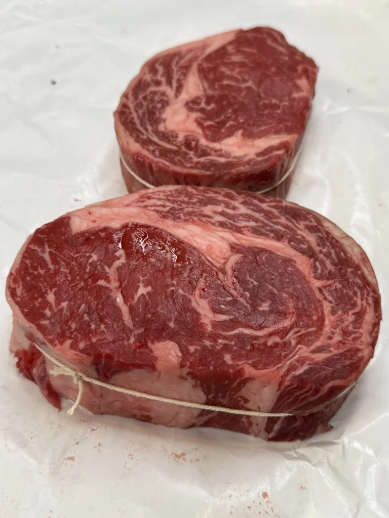 well marbled steak on a cutting board 