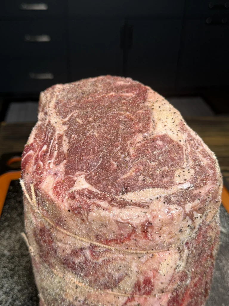 seasoned prime rib on the cutting board