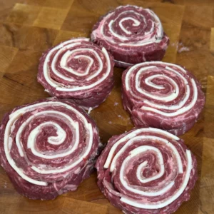 rolled up pinwheels on a cutting board