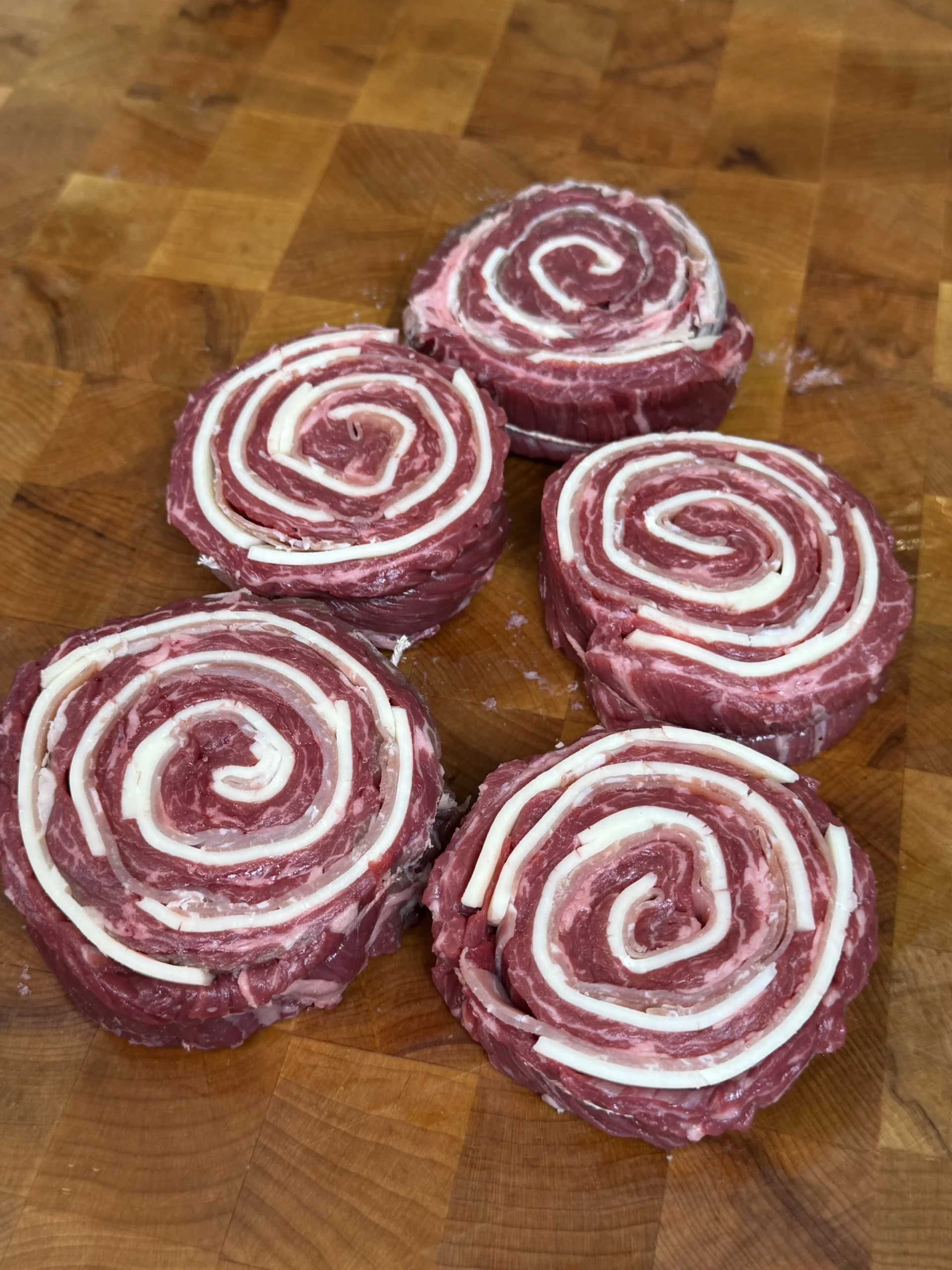 rolled up pinwheels on a cutting board