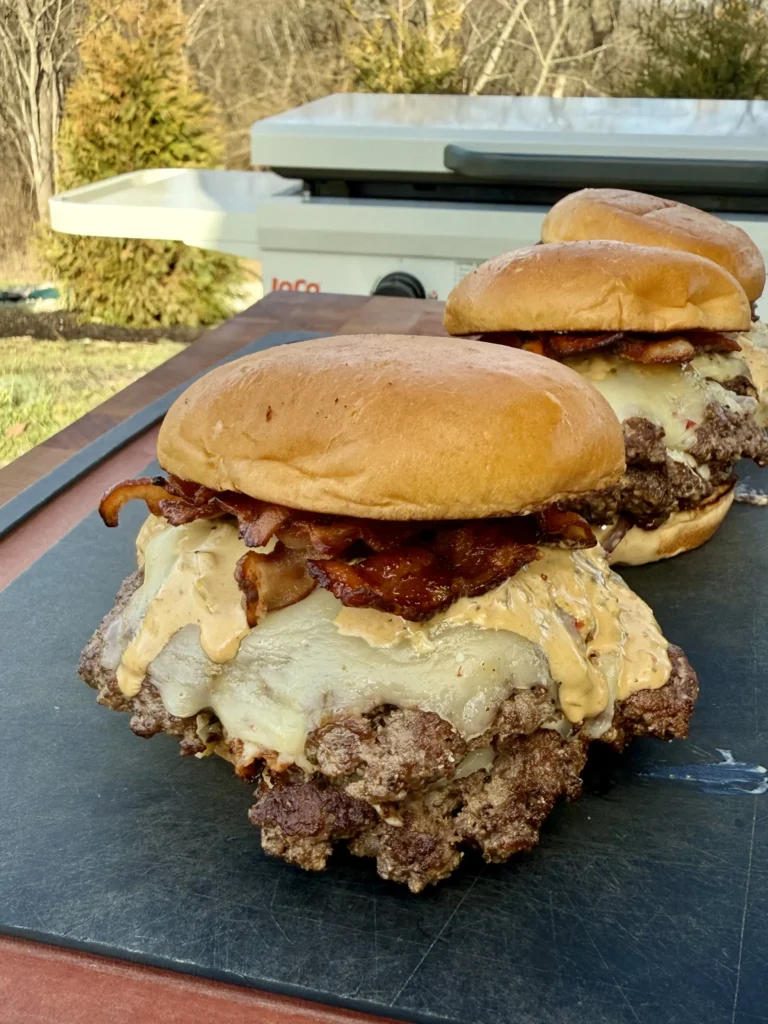Stacked double smash burger with crispy bacon and spicy jalapeño slices