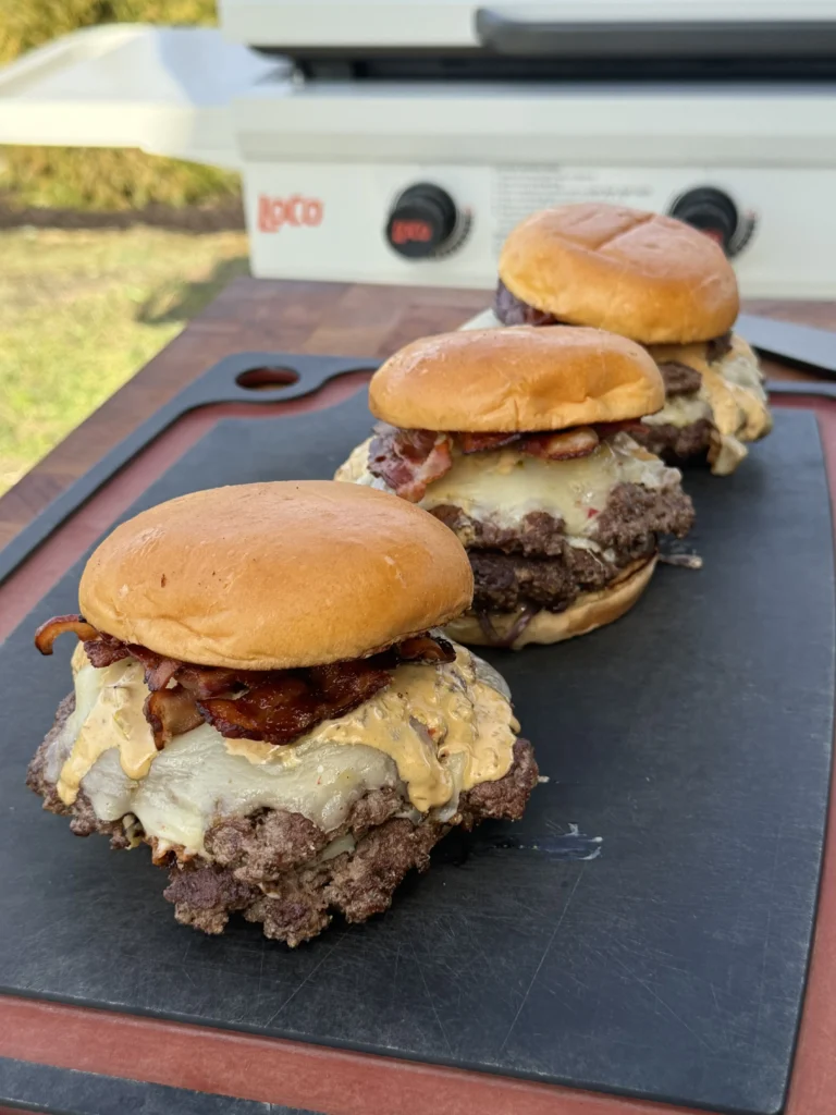 Overhead view of multiple smash burgers with golden brioche buns