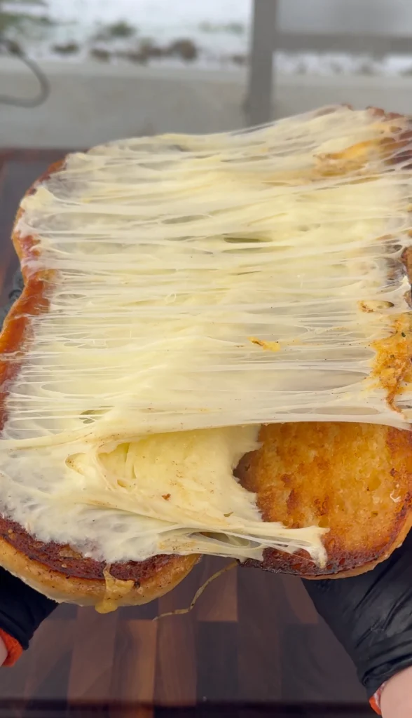 Juicy grilled chicken sandwich with bacon, melted cheddar, and fresh toppings on a toasted roll.