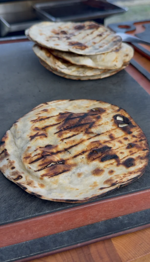 Tortillas being warmed on a dry skillet or open flame