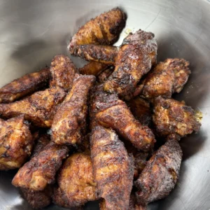 chicken wings in a bowl ready to be tossed