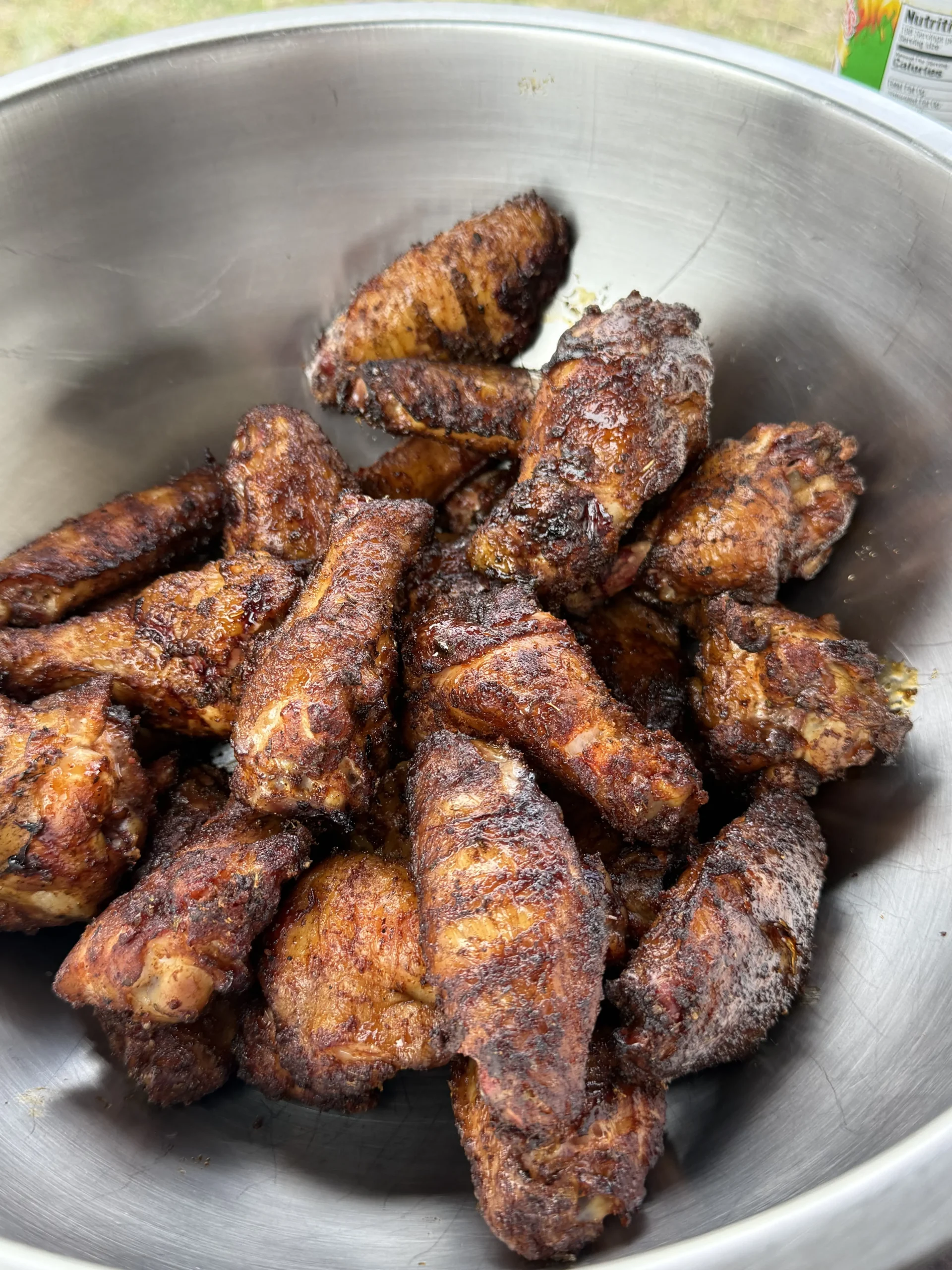 chicken wings in a bowl ready to be tossed