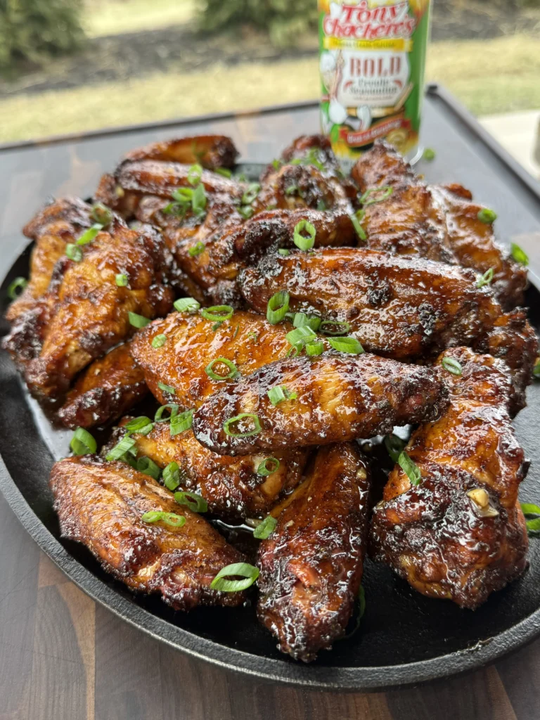 Served smoked hot honey chicken wings with a bottle of Tony's in the back