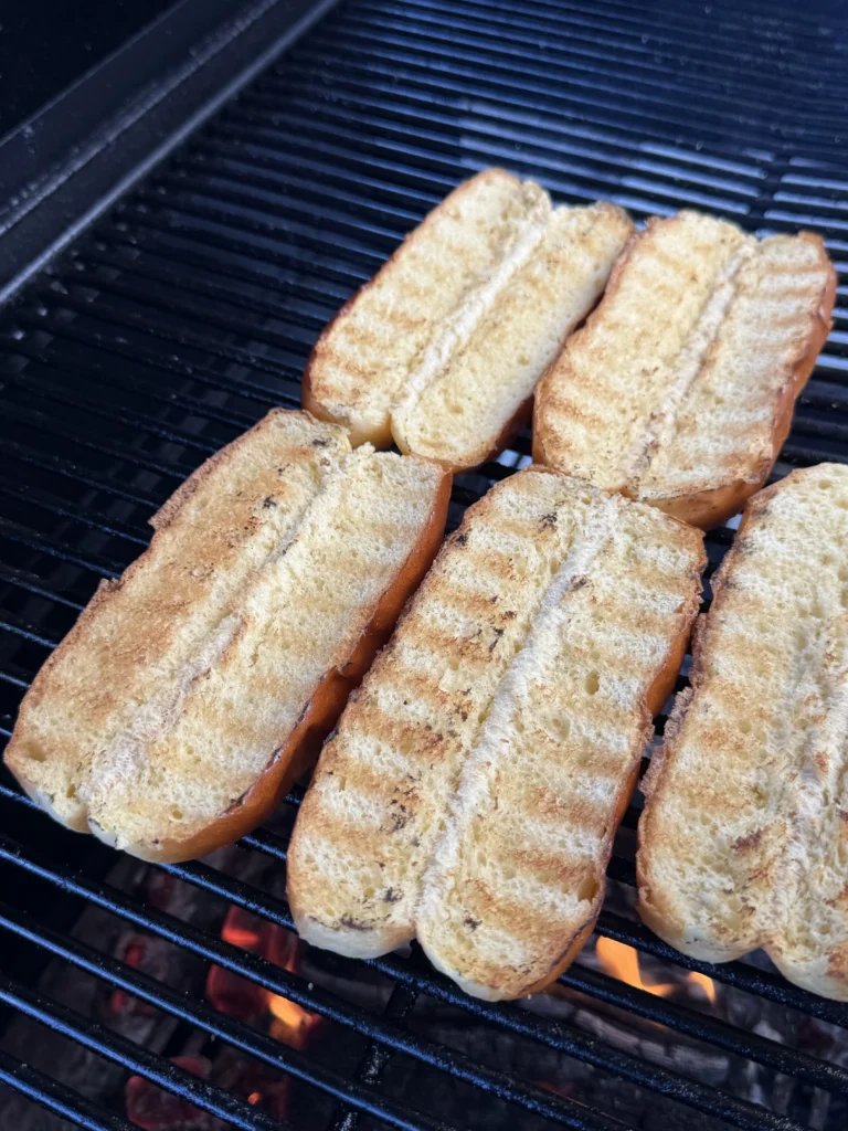toasting buns for the elote hot dogs