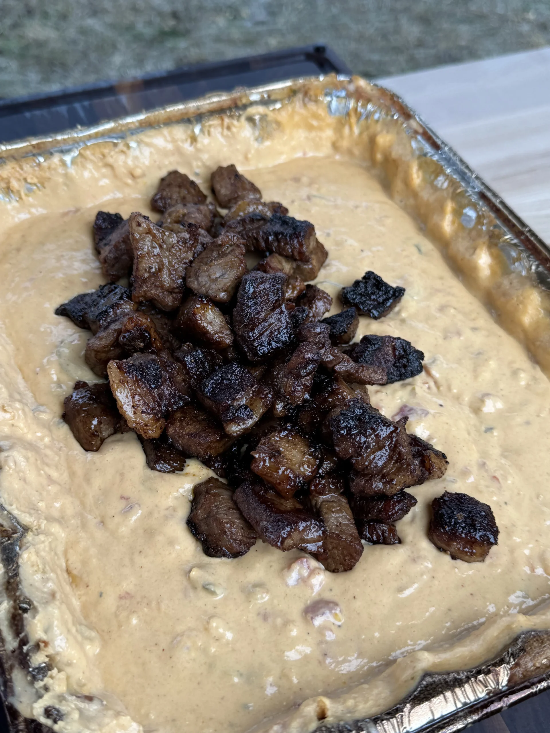steak bites in the smoked queso