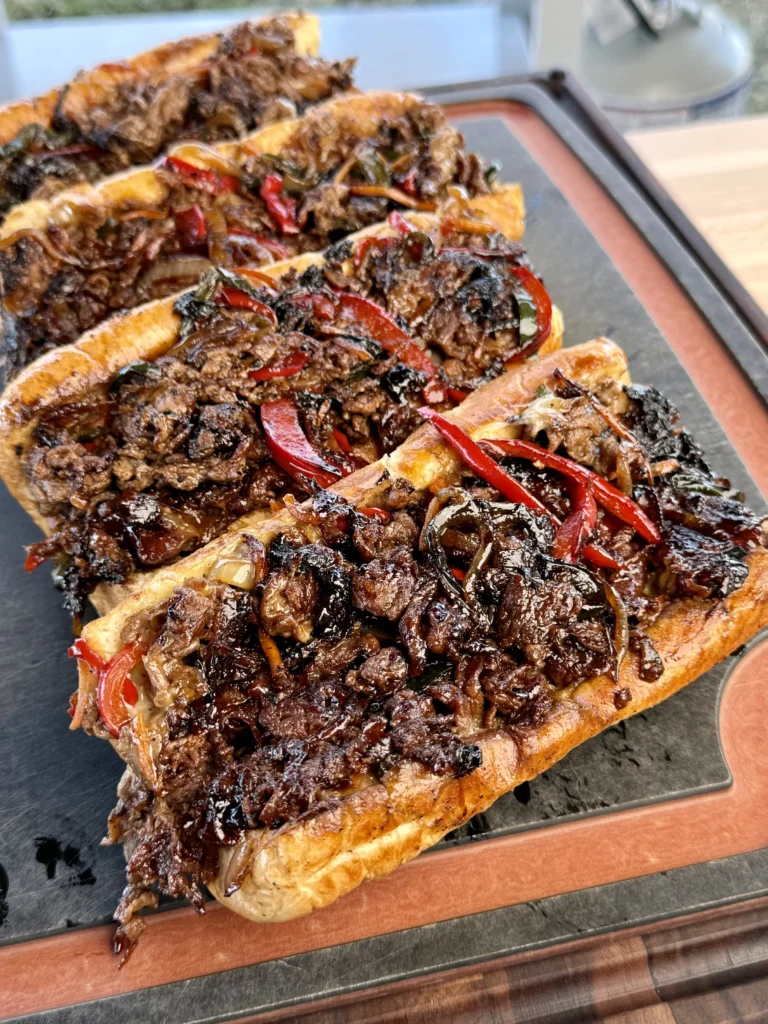 perfect ultimate griddled cheesesteaks on a cutting board
